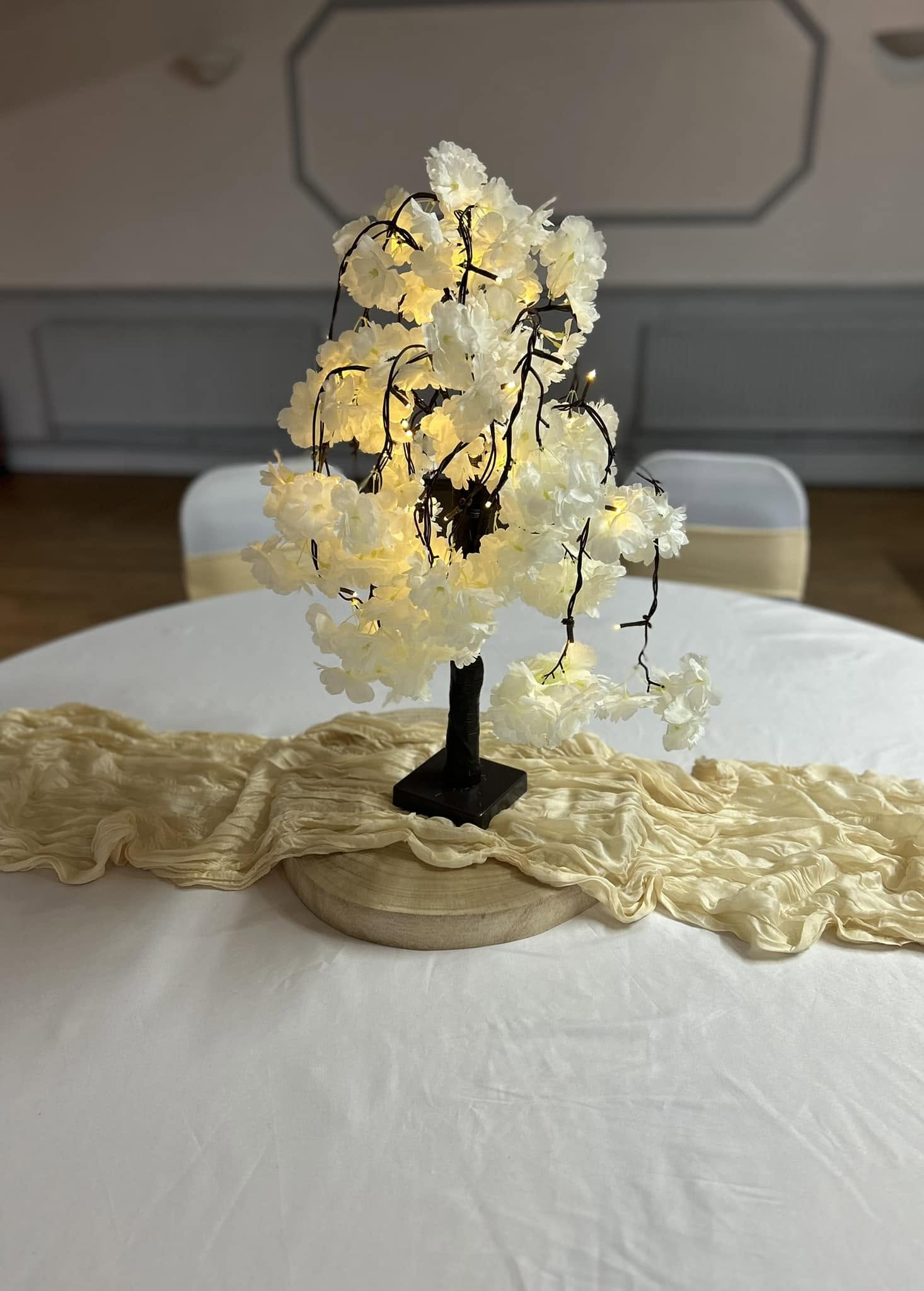 Light-up blossom tree centrepiece on a table with a champagne runner